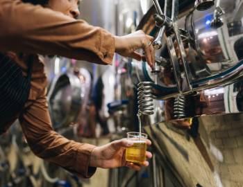 pouring drink at distillery